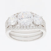 Round white Moissanite sterling silver ring with sparkling accents and three central stones.